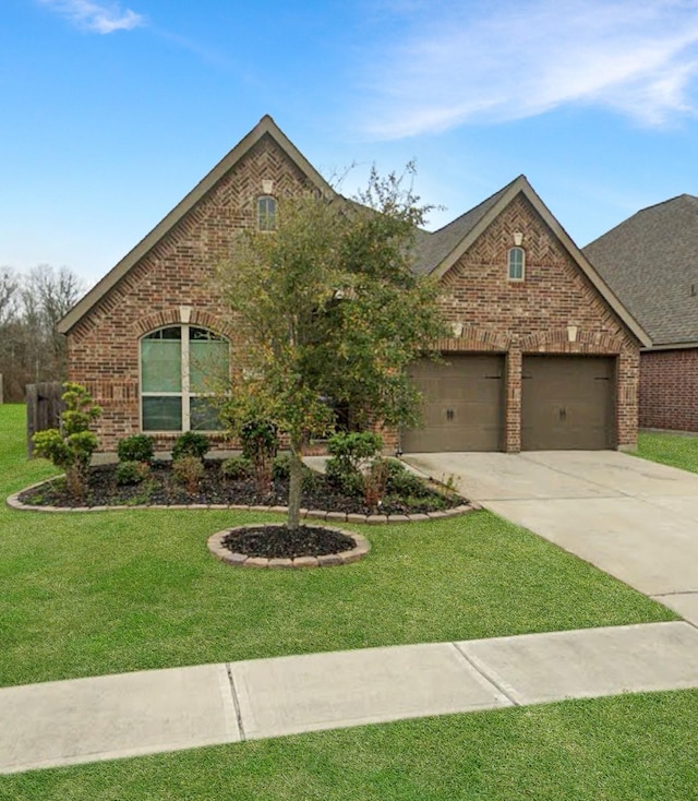 3328 Primrose Canyon Ln, Pearland, TX 77584 - view of front of house with brick siding, concrete driveway, an attached garage, and a front yard