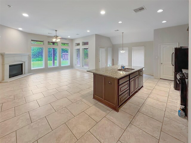 3328 Primrose Canyon Ln, Pearland, TX 77584 - kitchen with a ceiling fan, open floor plan, light tile patterned floors, light stone counters, and freestanding refrigerator