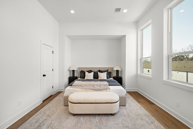 835 Rachel St Unit C, Houston, TX 77091 - bedroom featuring dark wood finished floors, multiple windows, baseboards, and recessed lighting