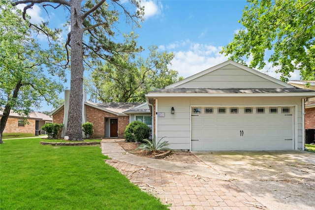10503 Windriver Dr, Houston, TX 77070 - view of front of home featuring a front lawn, concrete driveway, brick siding, and a garage