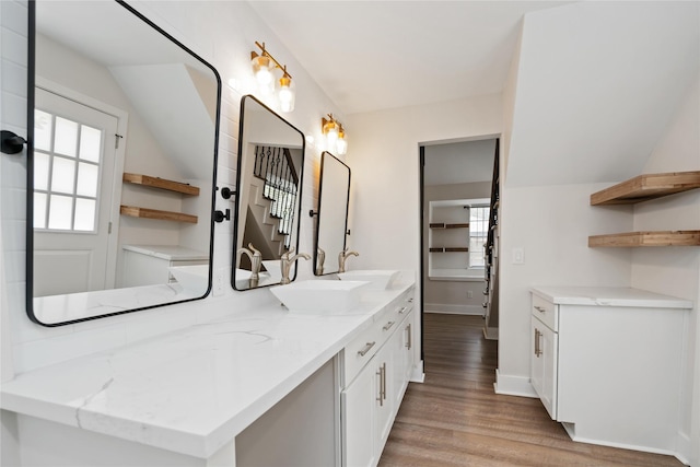 10503 Windriver Dr, Houston, TX 77070 - full bath featuring double vanity, wood finished floors, healthy amount of natural light, baseboards, and lofted ceiling