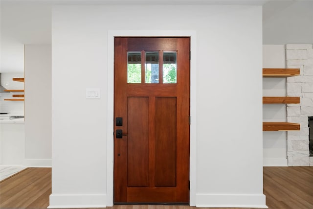 10503 Windriver Dr, Houston, TX 77070 - entryway featuring baseboards, wood finished floors, and a stone fireplace