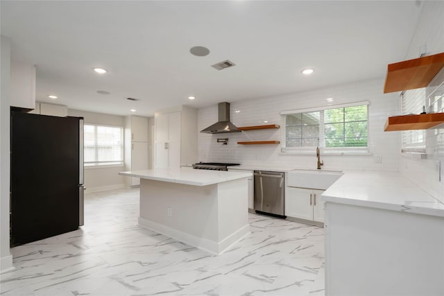 10503 Windriver Dr, Houston, TX 77070 - kitchen featuring stainless steel appliances, open shelves, wall chimney exhaust hood, a sink, and decorative backsplash