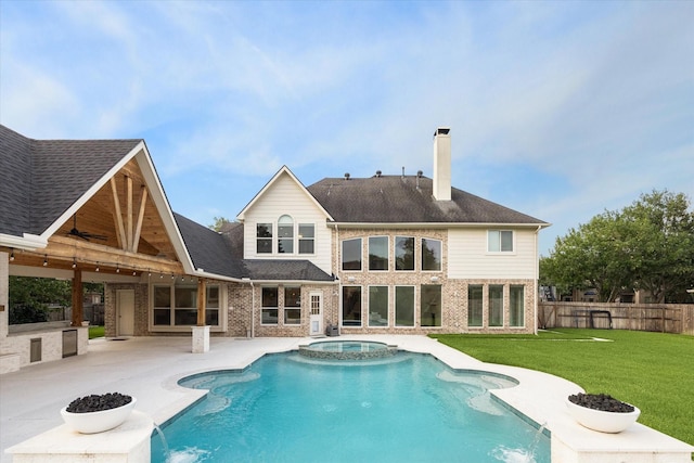 22111 Blacksburg Ct, Katy, TX 77450 - back of property with area for grilling, a chimney, a patio, ceiling fan, and a pool with connected hot tub