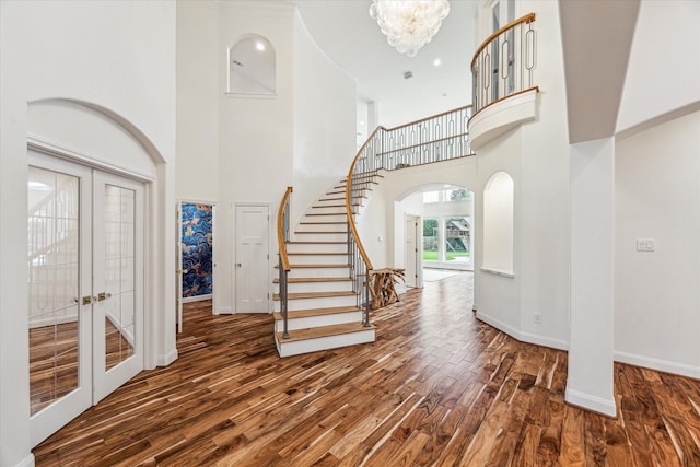 22111 Blacksburg Ct, Katy, TX 77450 - entryway with a high ceiling, wood finished floors, arched walkways, baseboards, and stairway