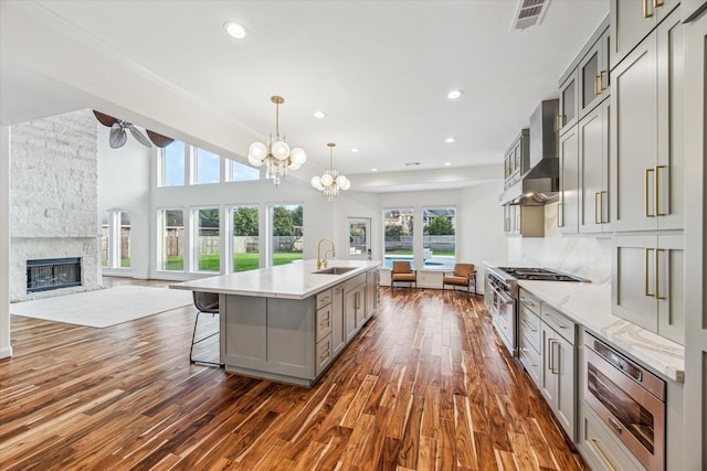 22111 Blacksburg Ct, Katy, TX 77450 - kitchen featuring gray cabinets, range with two ovens, dark wood-type flooring, open floor plan, and recessed lighting