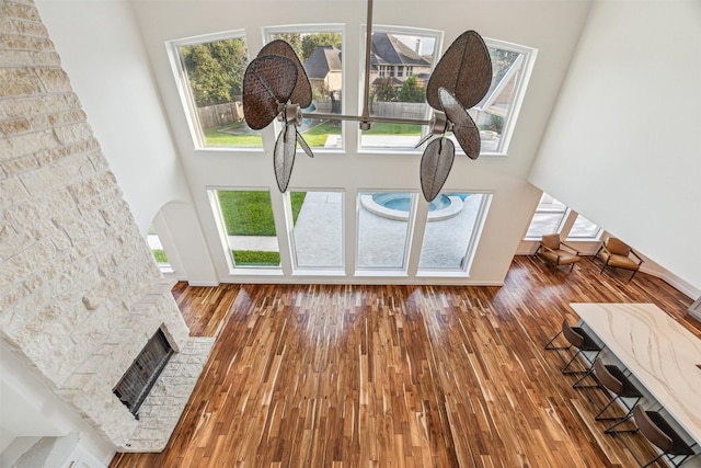 22111 Blacksburg Ct, Katy, TX 77450 - living area with a towering ceiling, a brick fireplace, wood finished floors, and baseboards