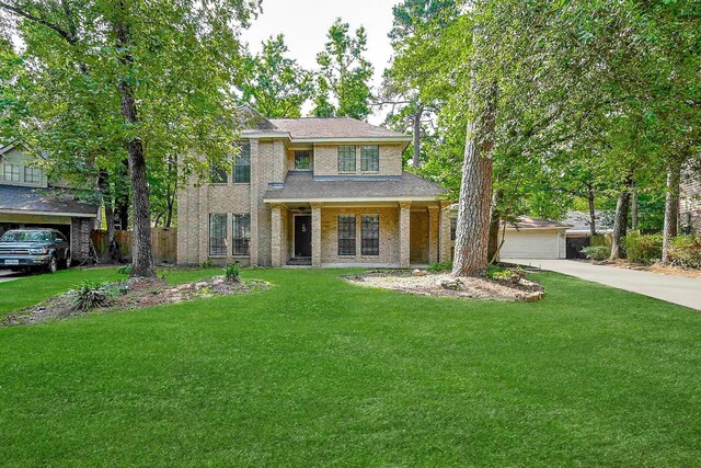 31 Silent Brook Pl, The Woodlands, TX 77381 - view of front of house featuring a front lawn