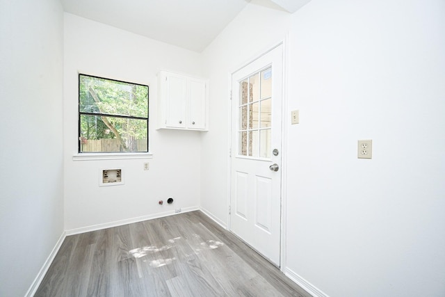 31 Silent Brook Pl, The Woodlands, TX 77381 - laundry area with cabinet space, washer hookup, light wood-type flooring, baseboards, and electric dryer hookup