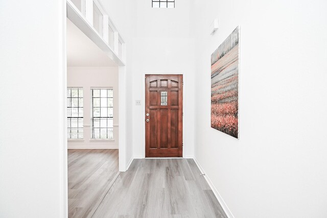 31 Silent Brook Pl, The Woodlands, TX 77381 - entryway featuring light wood finished floors and baseboards
