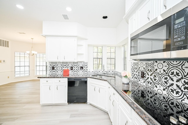 31 Silent Brook Pl, The Woodlands, TX 77381 - kitchen featuring black appliances, a sink, open shelves, a chandelier, and white cabinetry
