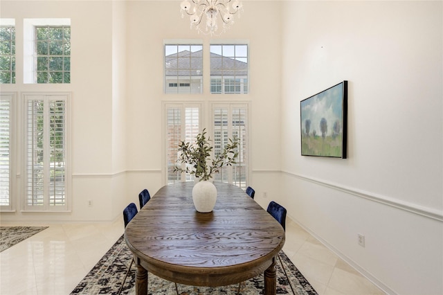 13515 N Tracewood Bnd, Houston, TX 77077 - dining room featuring a chandelier, light tile patterned floors, a towering ceiling, and baseboards