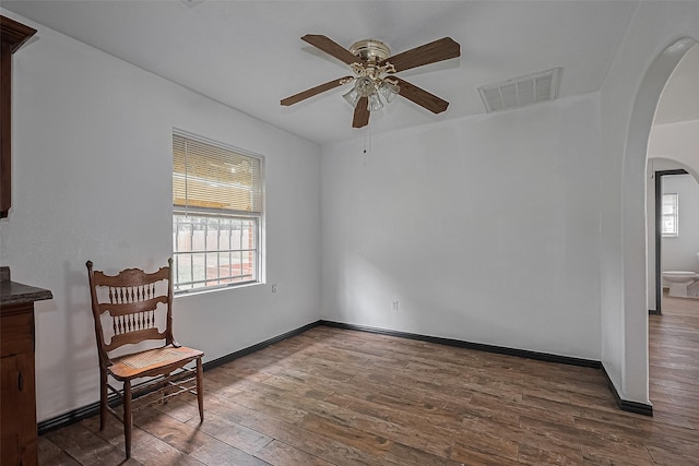 423 Gammon Dr, Houston, TX 77022 - unfurnished room with arched walkways, ceiling fan, and wood finished floors