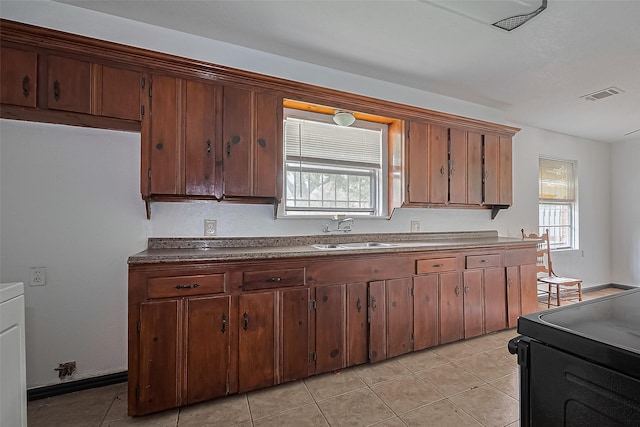 423 Gammon Dr, Houston, TX 77022 - kitchen featuring a sink, plenty of natural light, and light tile patterned floors