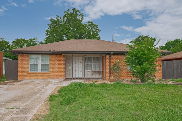 423 Gammon Dr, Houston, TX 77022 - view of front of home featuring brick siding and roof with shingles