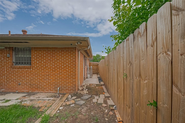 423 Gammon Dr, Houston, TX 77022 - view of side of home with brick siding and a fenced backyard