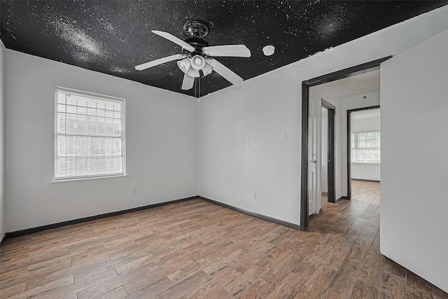 423 Gammon Dr, Houston, TX 77022 - spare room with wood finished floors, a ceiling fan, attic access, and baseboards