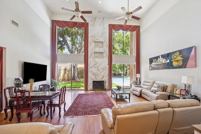 12007 Lakeway Ct, Houston, TX 77071 - living area with a high ceiling, ceiling fan, wood finished floors, and a premium fireplace