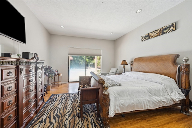 12007 Lakeway Ct, Houston, TX 77071 - bedroom featuring wood finished floors, recessed lighting, and a textured ceiling