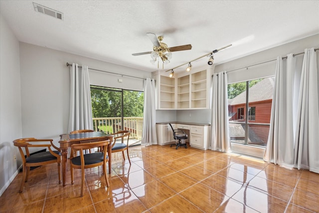12007 Lakeway Ct, Houston, TX 77071 - dining room featuring healthy amount of natural light, a ceiling fan, light tile patterned flooring, a textured ceiling, and baseboards