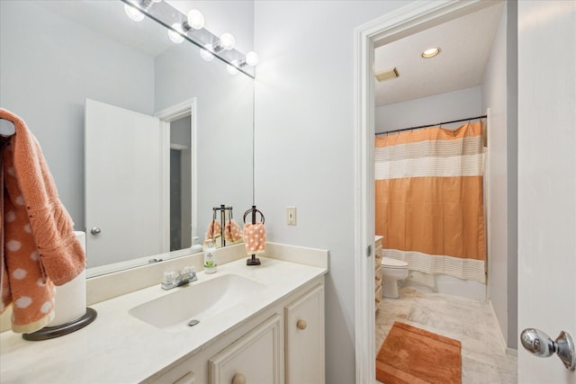 12007 Lakeway Ct, Houston, TX 77071 - full bath with vanity, marble look tiles, toilet, recessed lighting, and baseboards