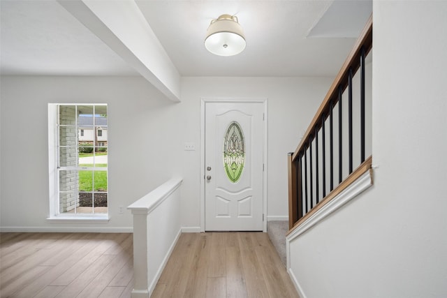 90 Crystal Lake Ln, The Woodlands, TX 77380 - entrance foyer featuring light wood finished floors, stairs, and baseboards