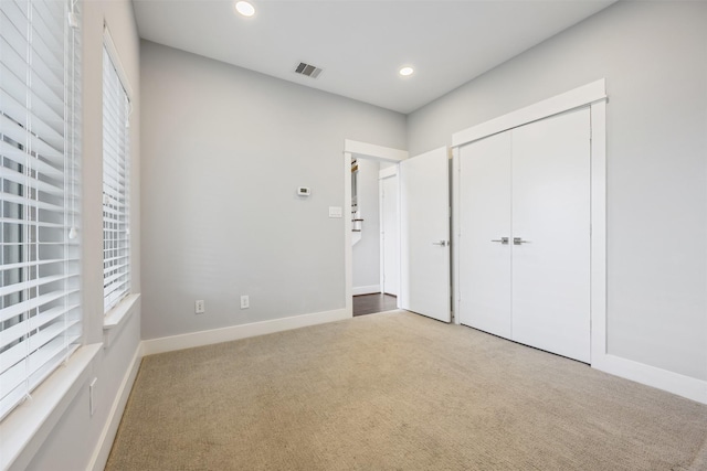 727 Schwartz St, Houston, TX 77020 - unfurnished bedroom featuring light colored carpet, recessed lighting, baseboards, and a closet