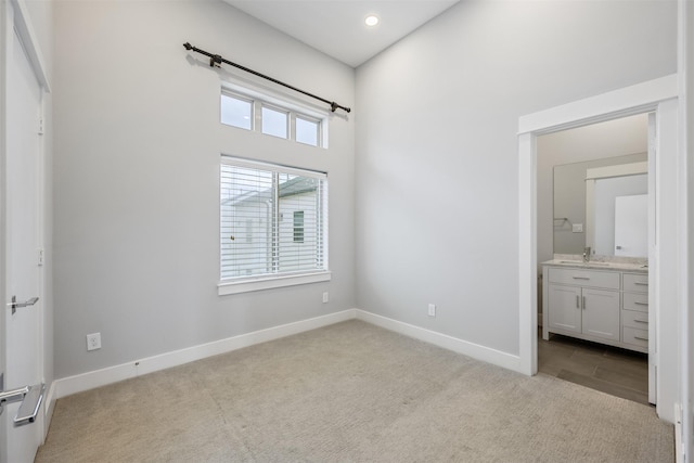 727 Schwartz St, Houston, TX 77020 - unfurnished bedroom with carpet, baseboards, connected bathroom, and recessed lighting