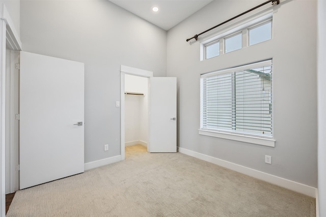 727 Schwartz St, Houston, TX 77020 - unfurnished bedroom with a high ceiling, baseboards, a walk in closet, carpet flooring, and recessed lighting