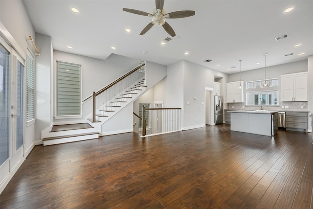 727 Schwartz St, Houston, TX 77020 - unfurnished living room with ceiling fan, dark wood finished floors, baseboards, stairs, and recessed lighting