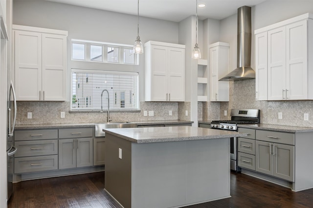 727 Schwartz St, Houston, TX 77020 - kitchen with appliances with stainless steel finishes, wall chimney range hood, a sink, a kitchen island, and backsplash