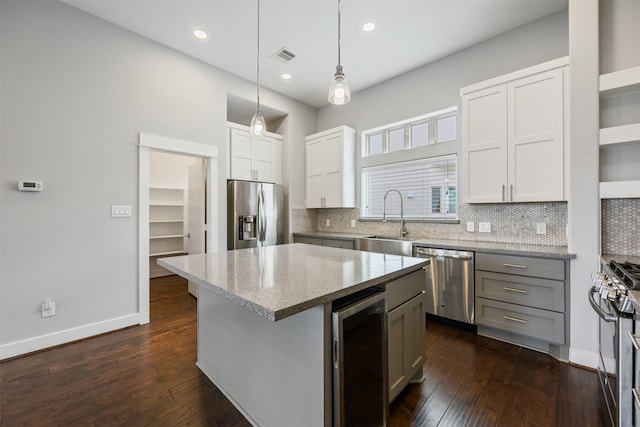 727 Schwartz St, Houston, TX 77020 - kitchen featuring stainless steel appliances, beverage cooler, a sink, dark wood-type flooring, and recessed lighting