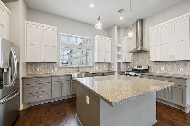727 Schwartz St, Houston, TX 77020 - kitchen with appliances with stainless steel finishes, wall chimney exhaust hood, gray cabinets, a center island, and a sink