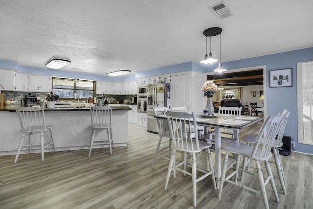 6462 US Highway 190 E, Livingston, TX 77351 - dining area featuring light wood finished floors and a textured ceiling