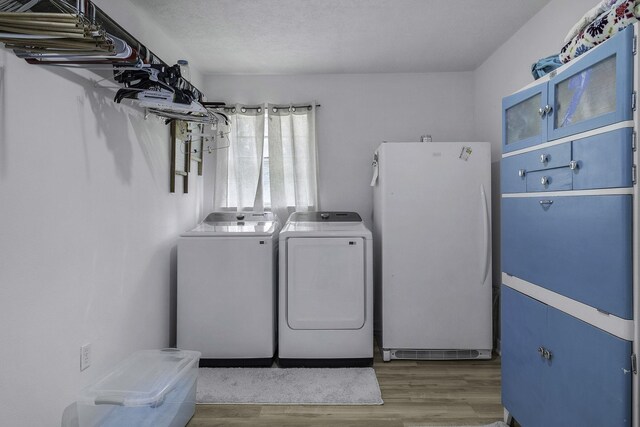 6462 US Highway 190 E, Livingston, TX 77351 - washroom featuring washer and clothes dryer and wood finished floors