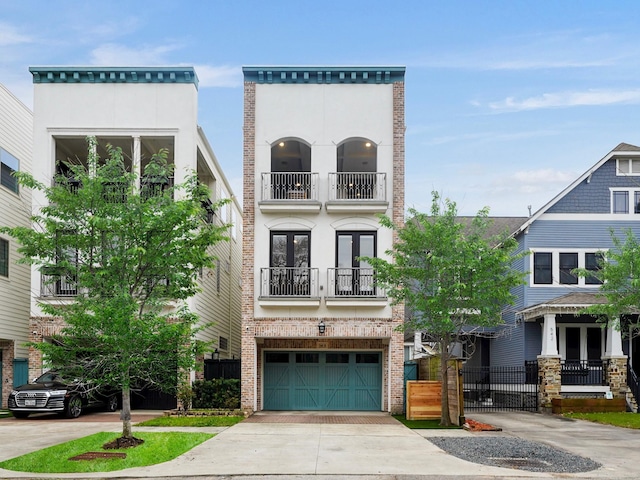 540 W 26th St Unit B, Houston, TX 77008 - multi unit property featuring french doors, a garage, concrete driveway, a balcony, and brick siding