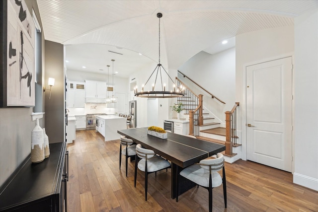 540 W 26th St Unit B, Houston, TX 77008 - dining space featuring beverage cooler, hardwood / wood-style floors, stairs, a chandelier, and recessed lighting