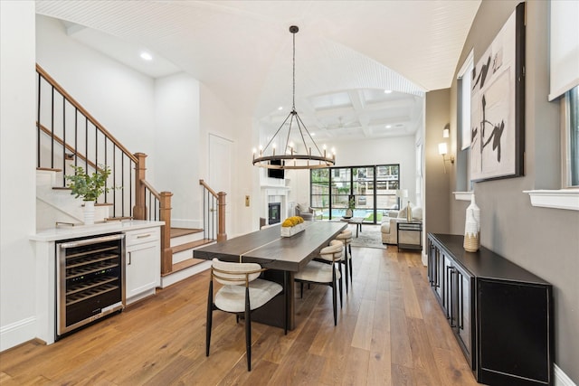 540 W 26th St Unit B, Houston, TX 77008 - dining room with wine cooler, stairway, a chandelier, coffered ceiling, and light wood-style floors