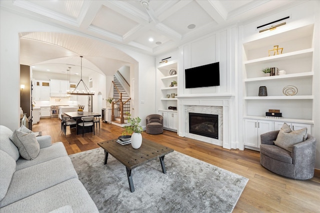 540 W 26th St Unit B, Houston, TX 77008 - living area featuring a premium fireplace, light wood-style flooring, coffered ceiling, built in features, and crown molding