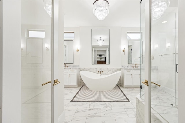 540 W 26th St Unit B, Houston, TX 77008 - full bath featuring marble look tile flooring, a stall shower, two vanities, a chandelier, and a wainscoted wall