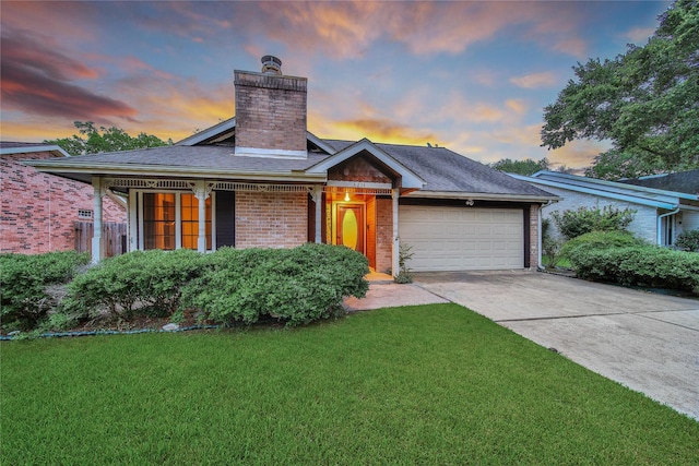 4214 Hambledon Village Dr, Houston, TX 77014 - view of front of home with a garage, driveway, a lawn, a chimney, and brick siding