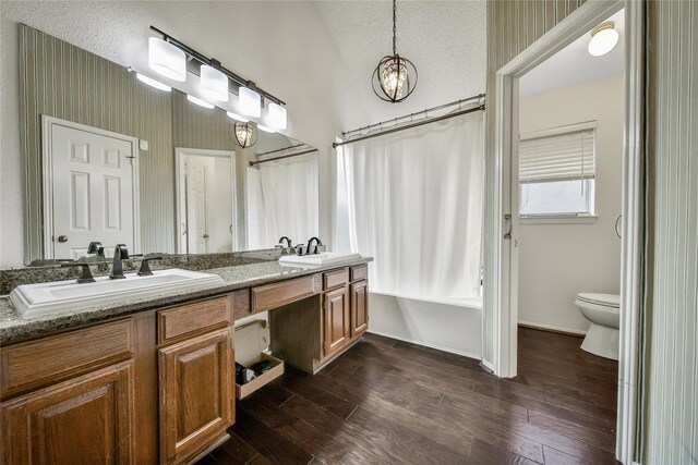 4214 Hambledon Village Dr, Houston, TX 77014 - bathroom featuring double vanity, shower / tub combo with curtain, toilet, wood finished floors, and a chandelier