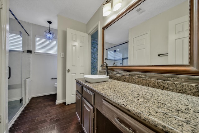 4214 Hambledon Village Dr, Houston, TX 77014 - full bathroom featuring wood finished floors, a stall shower, vanity, toilet, and a chandelier