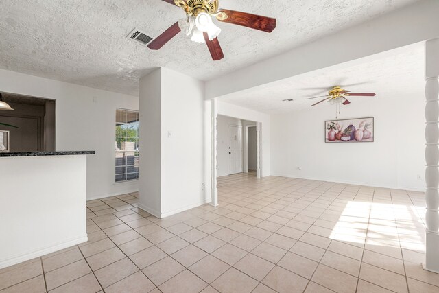 10431 Sagewillow Ln, Houston, TX 77089 - unfurnished living room with a ceiling fan, light tile patterned floors, a textured ceiling, and baseboards