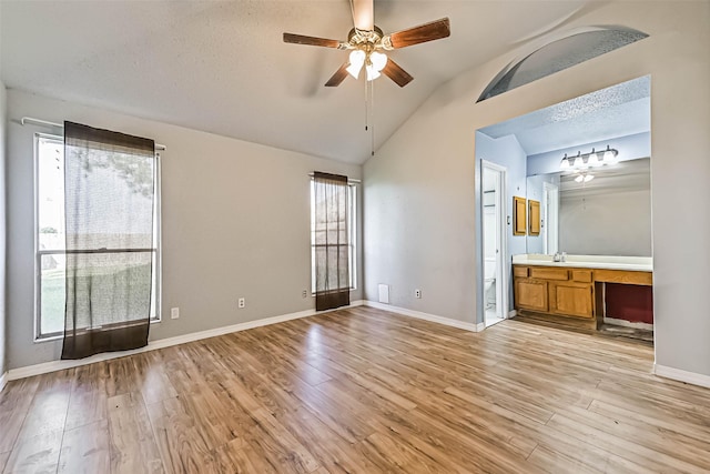 3419 Gladwyne Ln, La Porte, TX 77571 - unfurnished bedroom featuring vaulted ceiling, light wood finished floors, connected bathroom, and baseboards