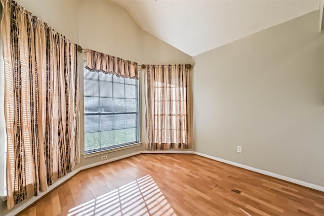 3419 Gladwyne Ln, La Porte, TX 77571 - empty room with lofted ceiling, wood finished floors, and baseboards