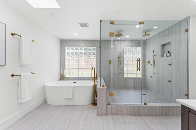 1100 S Shepherd Dr, Houston, TX 77019 - bathroom with a stall shower, a soaking tub, healthy amount of natural light, a skylight, and recessed lighting