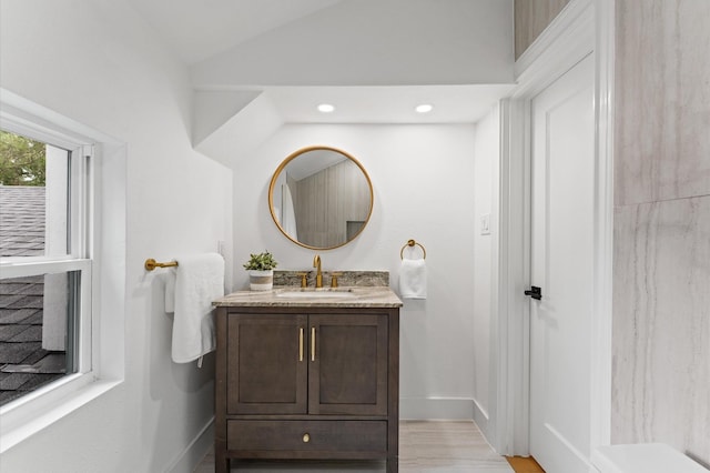 1100 S Shepherd Dr, Houston, TX 77019 - bathroom with vanity, lofted ceiling, recessed lighting, and wood finished floors