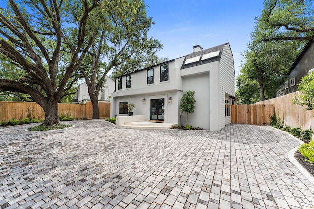 1100 S Shepherd Dr, Houston, TX 77019 - contemporary home with stucco siding, a chimney, and french doors