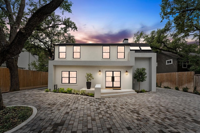 1100 S Shepherd Dr, Houston, TX 77019 - view of front of home featuring decorative driveway, stucco siding, and a chimney